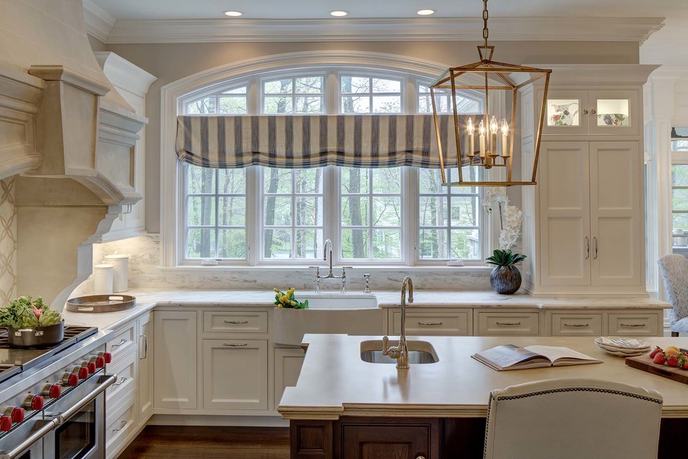 Inspiration for a traditional l-shaped kitchen in New York with a farmhouse sink, beaded inset cabinets, white cabinets, stainless steel appliances, with island and concrete benchtops.