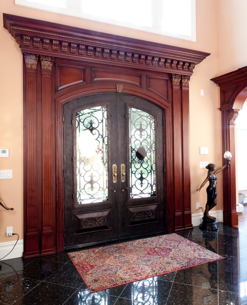 This is an example of a small traditional front door in New York with orange walls and a double front door.