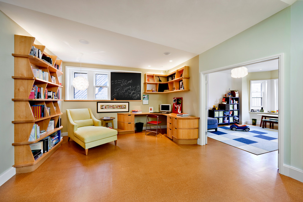 Photo of a contemporary home office in Boston with a built-in desk and cork floors.
