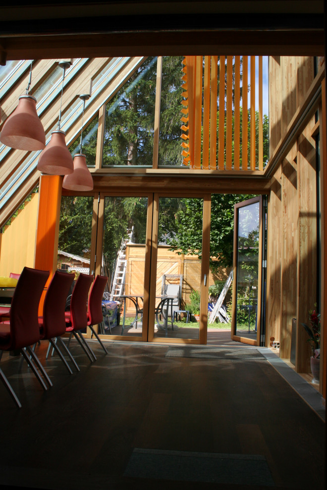Großer Mediterraner Wintergarten mit dunklem Holzboden, Glasdecke und braunem Boden in Sonstige