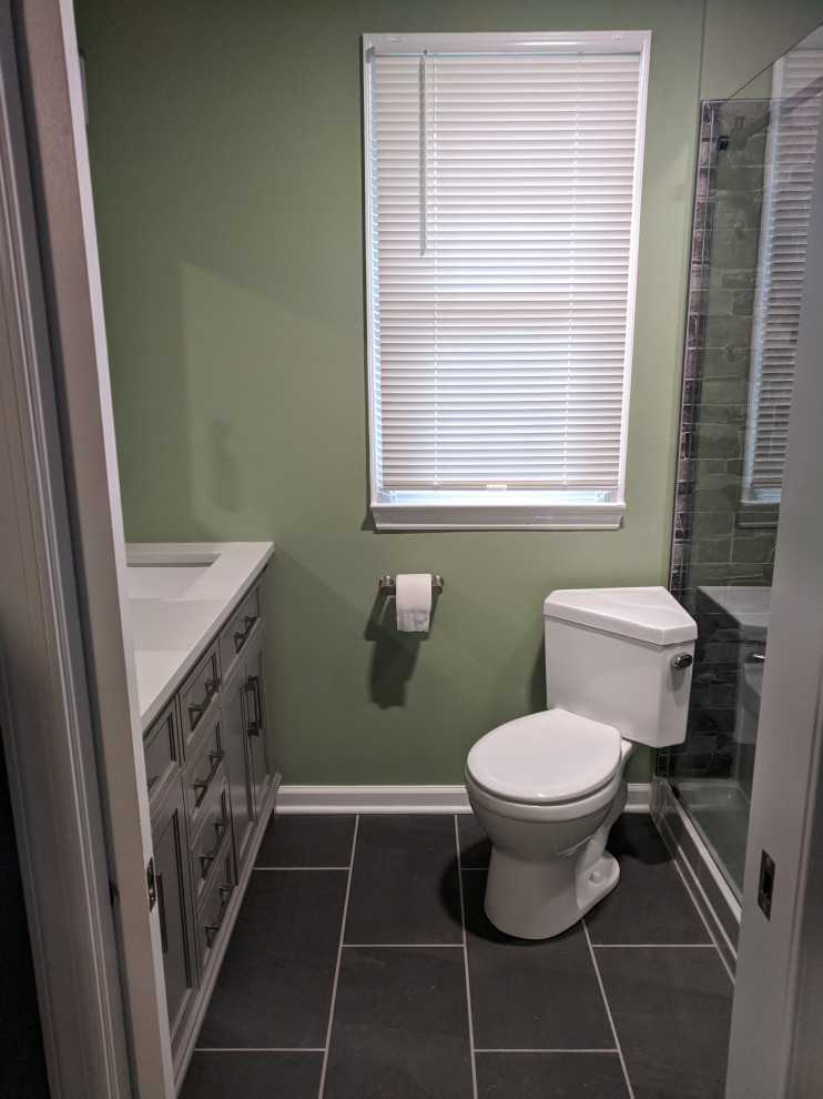 Inspiration for a small modern ensuite bathroom in Wilmington with grey cabinets, an alcove shower, slate flooring, engineered stone worktops, black floors, a sliding door, white worktops, double sinks and a freestanding vanity unit.