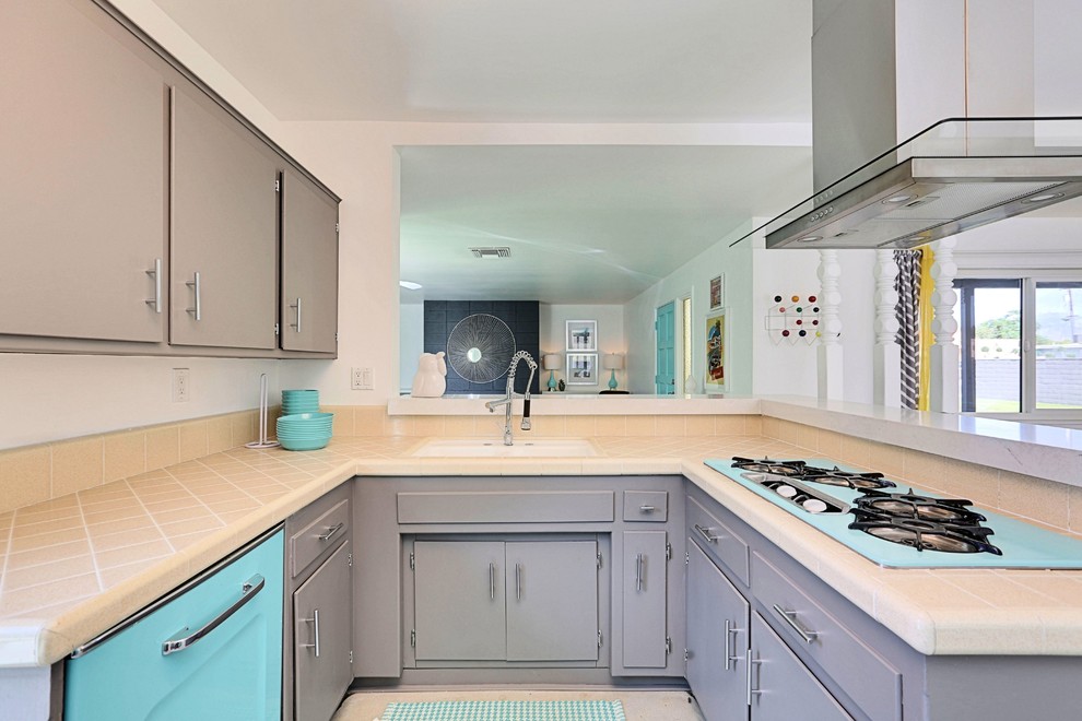 Inspiration for a small midcentury u-shaped open plan kitchen in Phoenix with an integrated sink, flat-panel cabinets, grey cabinets, tile benchtops, orange splashback, porcelain splashback, coloured appliances and concrete floors.