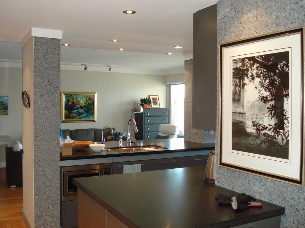 Inspiration for a small transitional single-wall light wood floor eat-in kitchen remodel in Orange County with a double-bowl sink, flat-panel cabinets, gray cabinets, quartz countertops, gray backsplash, mosaic tile backsplash and stainless steel appliances