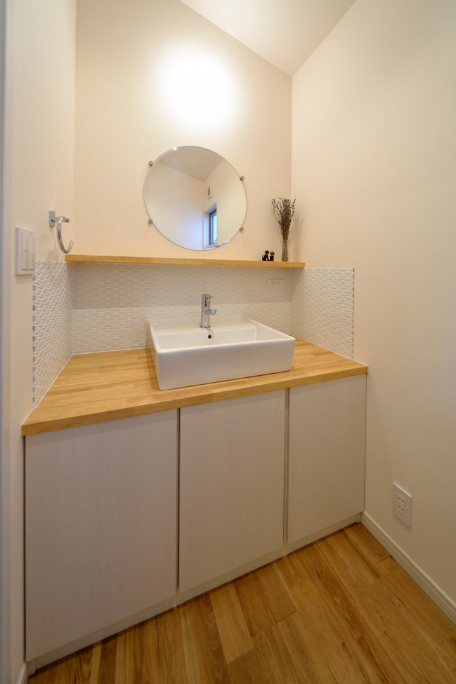 This is an example of a modern powder room in Other with a drop-in sink.