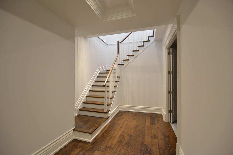 Design ideas for a traditional wood l-shaped staircase in Toronto with painted wood risers and wood railing.