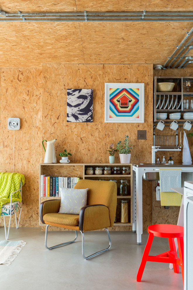 This is an example of a small urban living room in London with concrete flooring, a wood ceiling and wood walls.