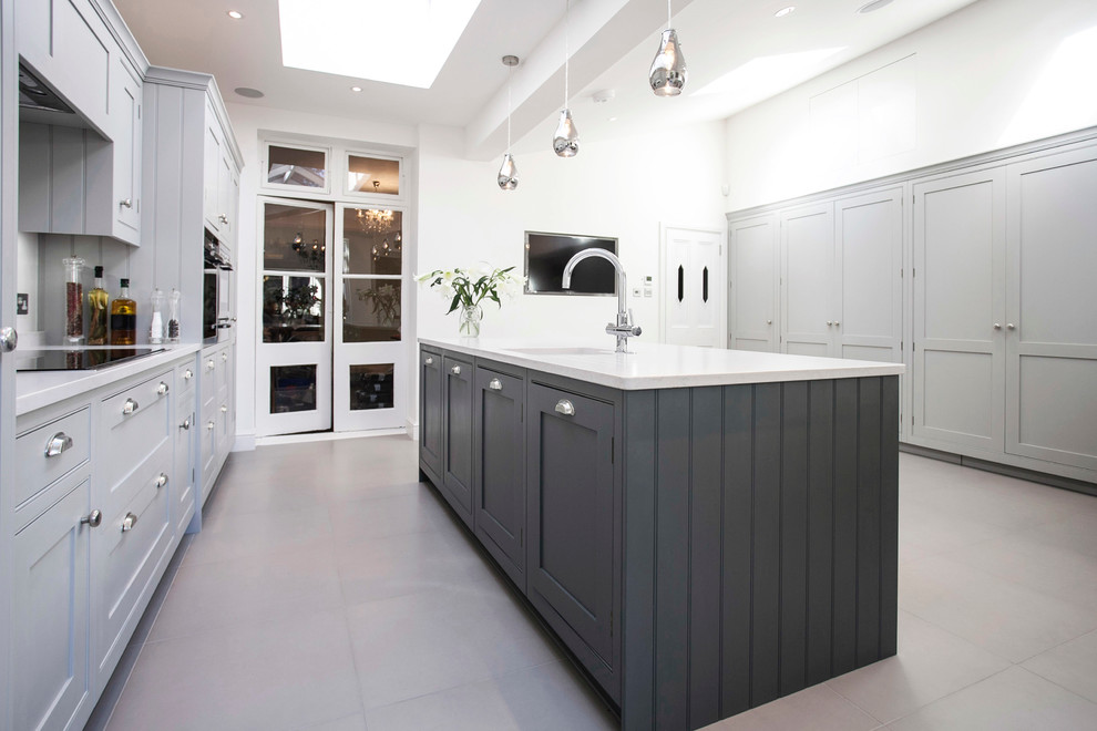 Design ideas for a large contemporary u-shaped eat-in kitchen in London with a single-bowl sink, shaker cabinets, grey cabinets, granite benchtops, ceramic floors, with island, white splashback, ceramic splashback, panelled appliances, white floor and white benchtop.