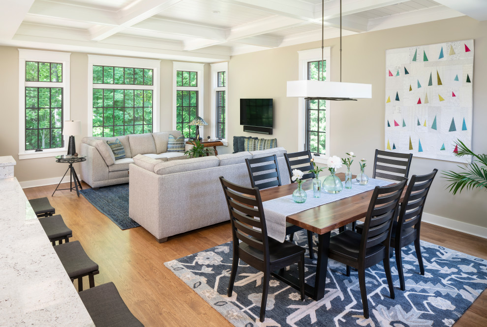 Example of a large classic open concept medium tone wood floor and brown floor dining room design in Detroit with beige walls, no fireplace and a wall-mounted tv