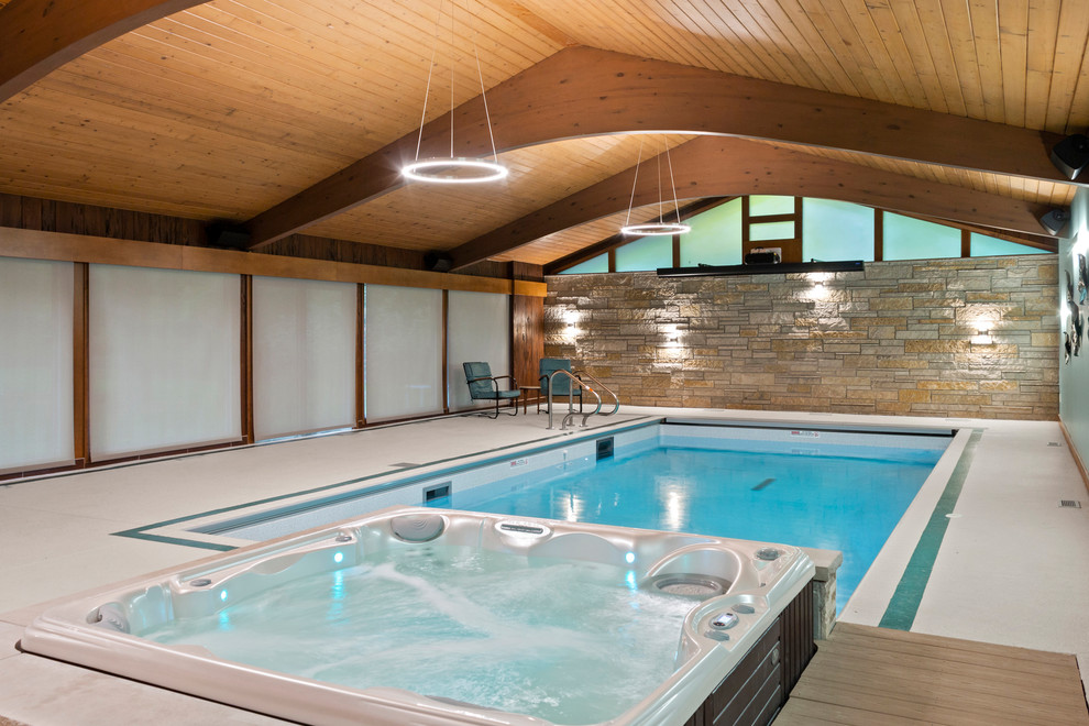 Inspiration for a small midcentury indoor rectangular pool in Milwaukee with a hot tub and concrete slab.