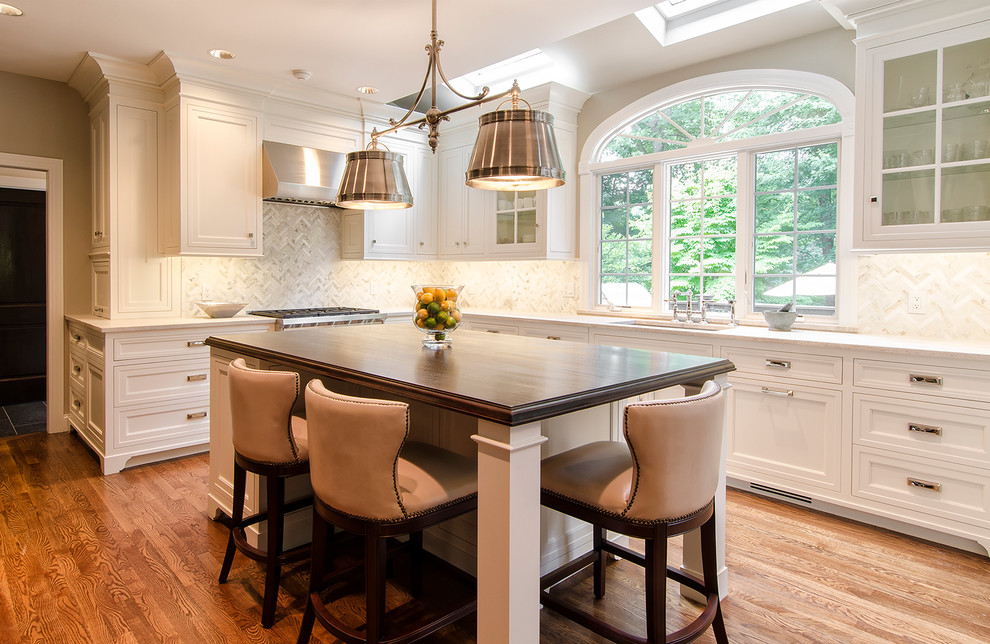 Inspiration for a large transitional u-shaped dark wood floor open concept kitchen remodel in New York with an undermount sink, recessed-panel cabinets, dark wood cabinets, quartzite countertops, white backsplash, stone tile backsplash, paneled appliances and an island