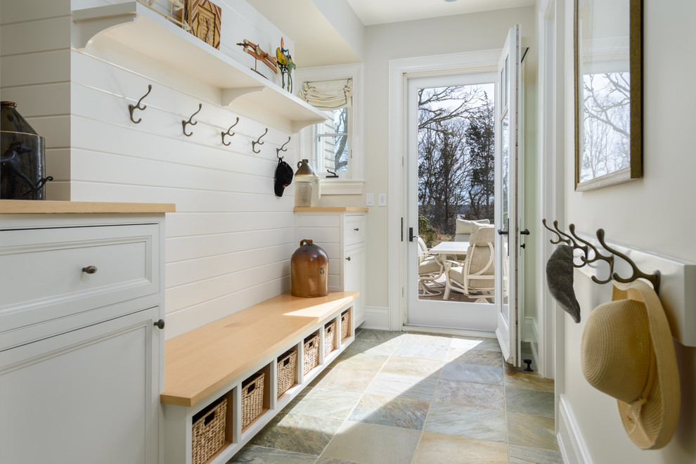 This is an example of a country entryway in Boston with beige walls, a single front door and a glass front door.