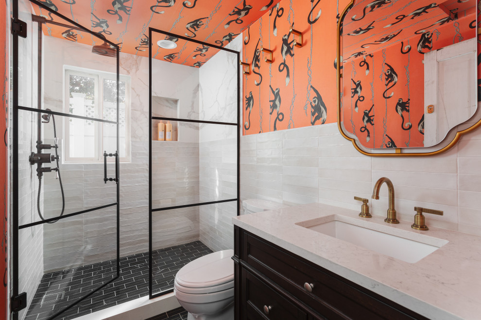Transitional white tile black floor, single-sink and wallpaper alcove shower photo in Orange County with shaker cabinets, black cabinets, orange walls, an undermount sink, a hinged shower door, white countertops, a niche and a freestanding vanity