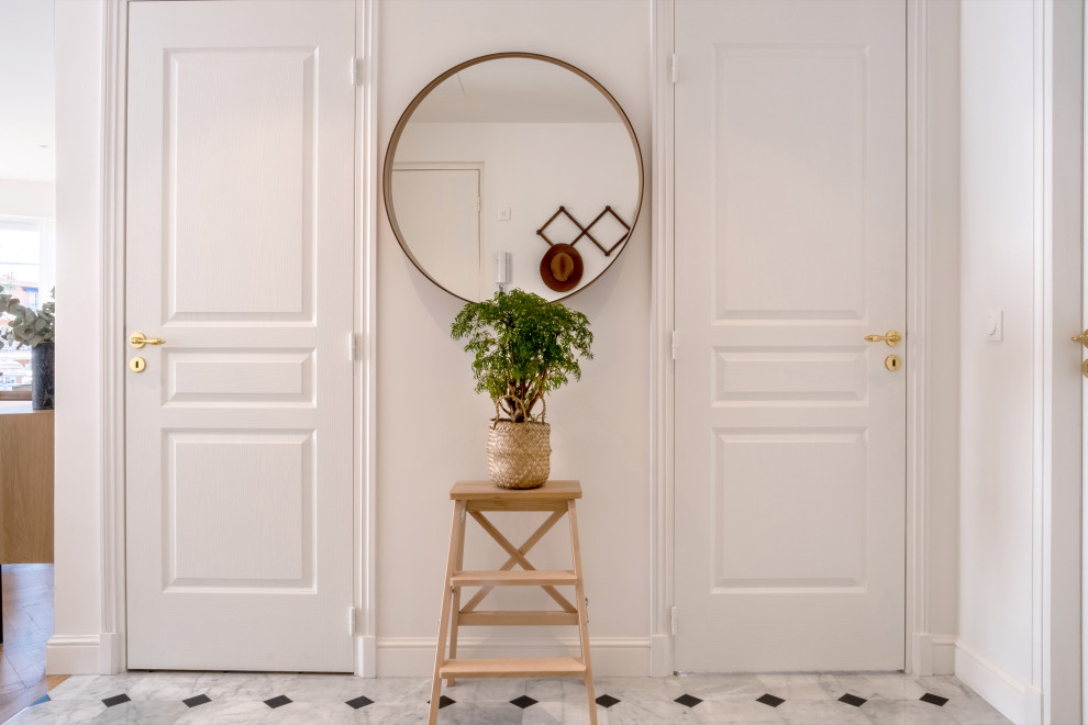 Пример оригинального дизайна: фойе среднего размера в стиле неоклассика (современная классика) с белыми стенами, мраморным полом, поворотной входной дверью, синей входной дверью, белым полом и кессонным потолком