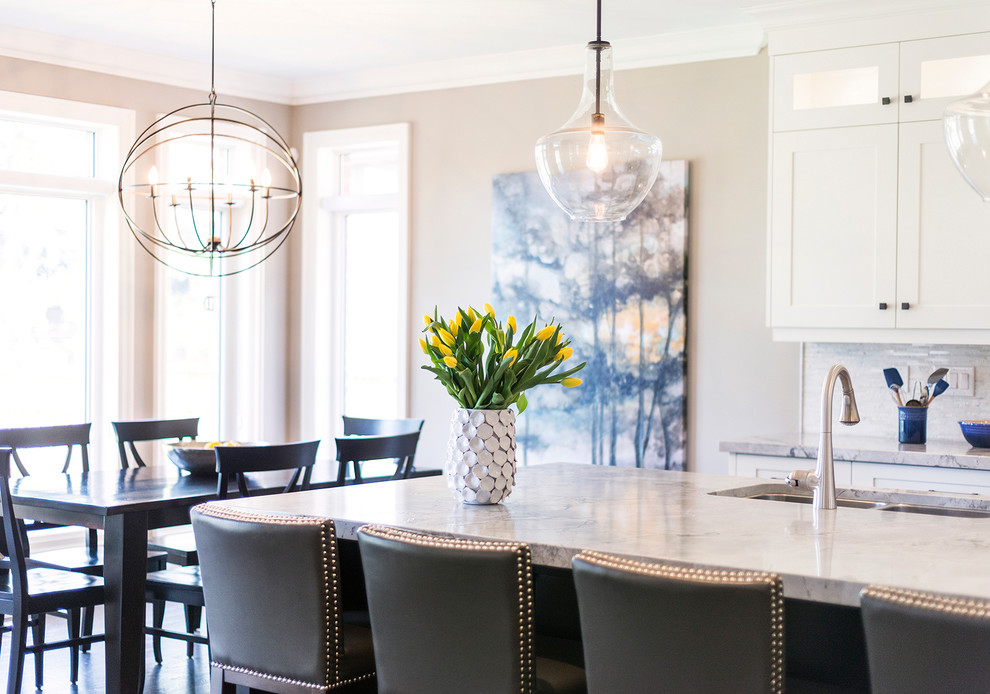 Example of a large transitional l-shaped dark wood floor open concept kitchen design in Toronto with an undermount sink, recessed-panel cabinets, white cabinets, quartzite countertops, multicolored backsplash, mosaic tile backsplash, stainless steel appliances and an island