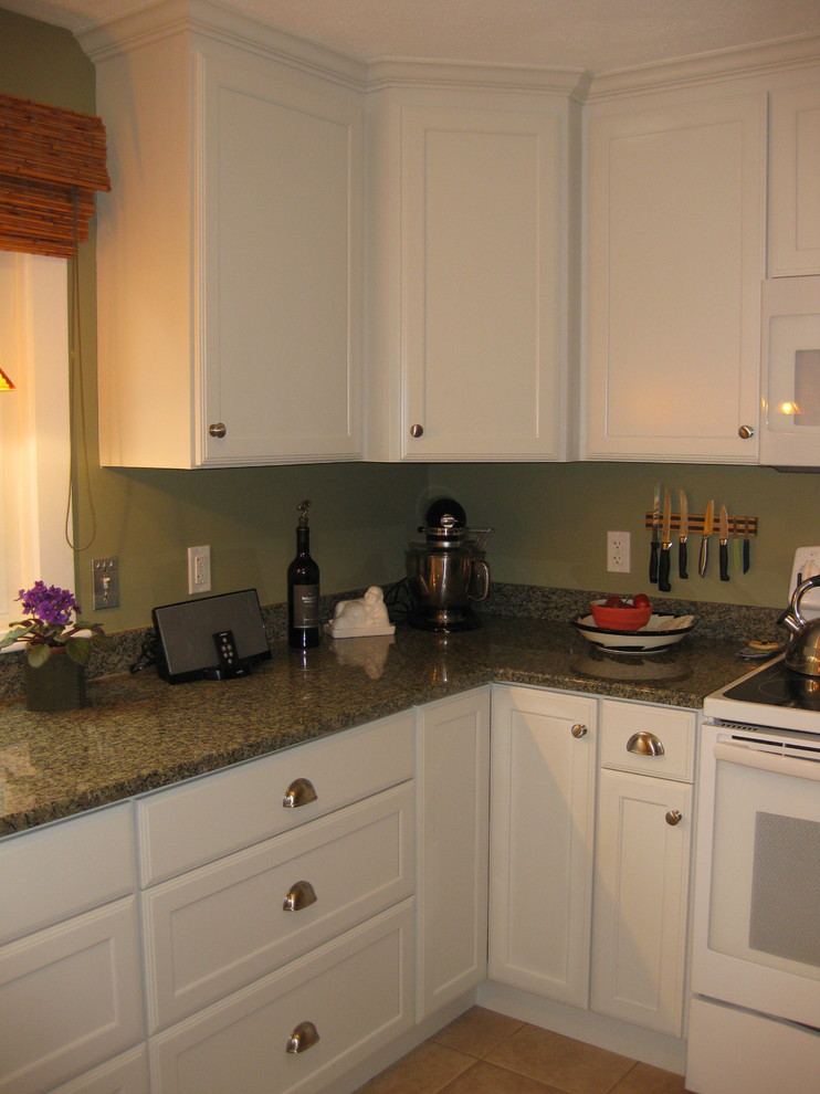 Kitchen - transitional l-shaped ceramic tile and beige floor kitchen idea in Boston with an undermount sink, shaker cabinets, white cabinets, granite countertops, white appliances and green countertops