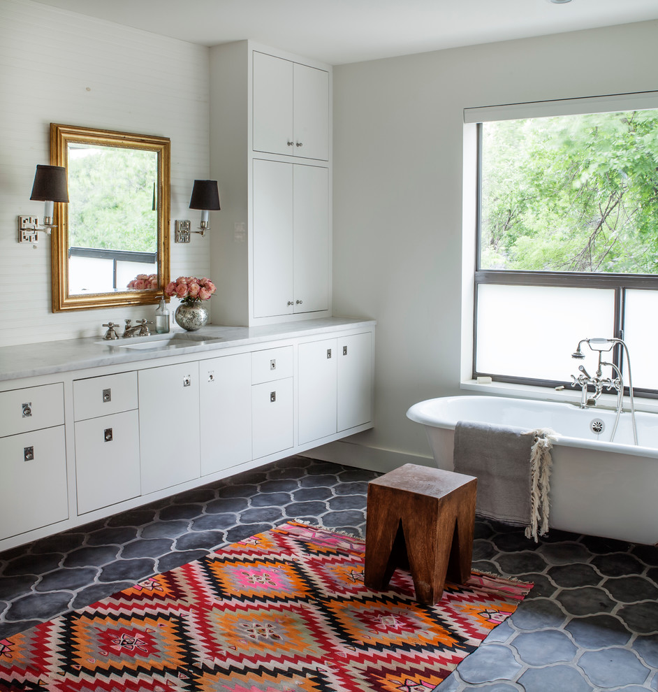 Transitional bathroom in Austin with an undermount sink, flat-panel cabinets, white cabinets, a claw-foot tub, white tile and white walls.