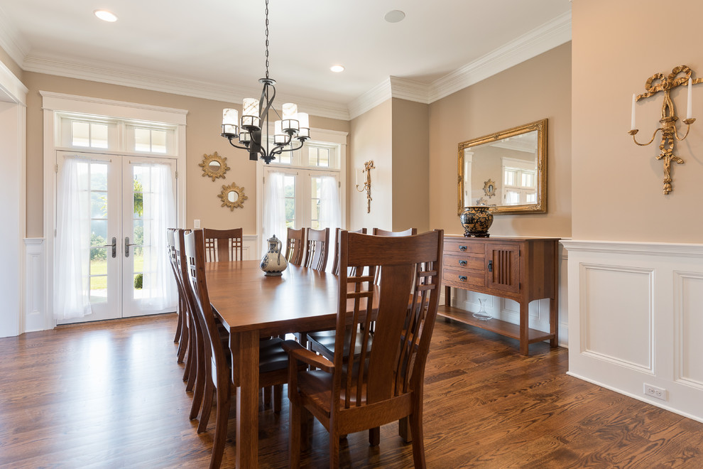 Example of a mid-sized transitional dark wood floor and brown floor enclosed dining room design with beige walls