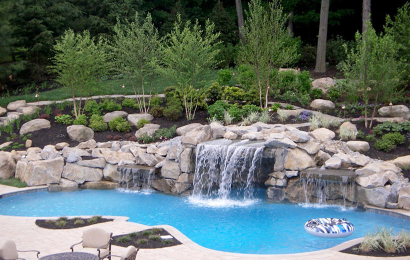 Large transitional backyard stone and custom-shaped pool fountain photo in Toronto