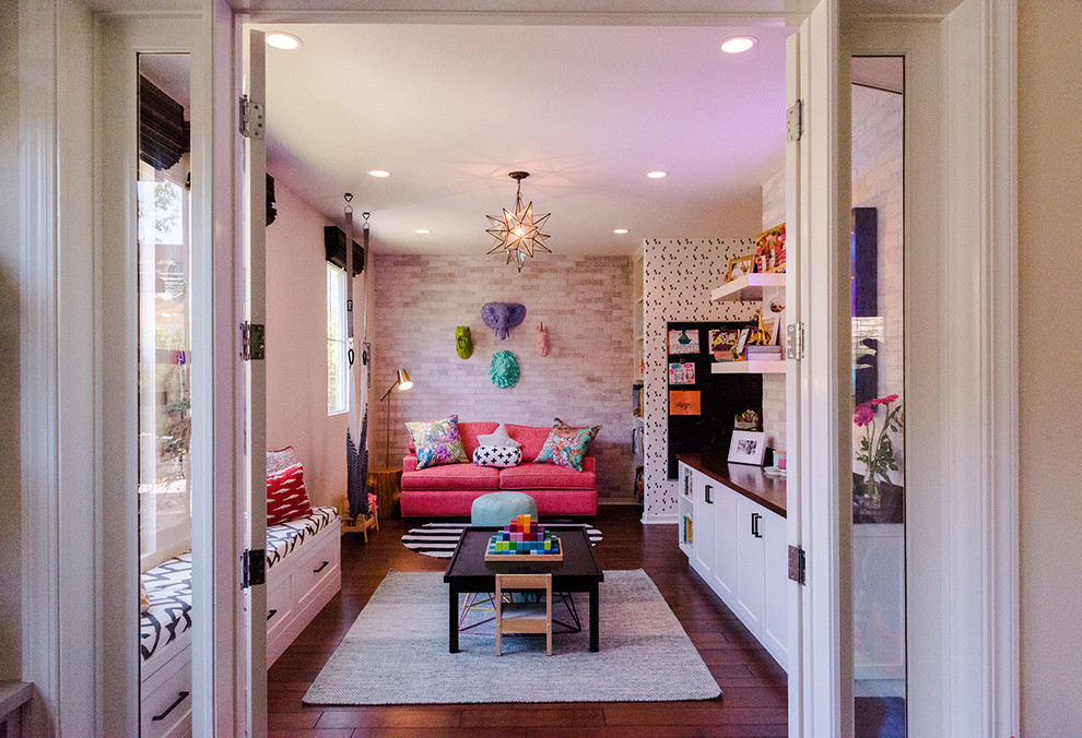 Photo of a mid-sized contemporary gender-neutral kids' playroom for kids 4-10 years old in Orange County with medium hardwood floors and brown floor.