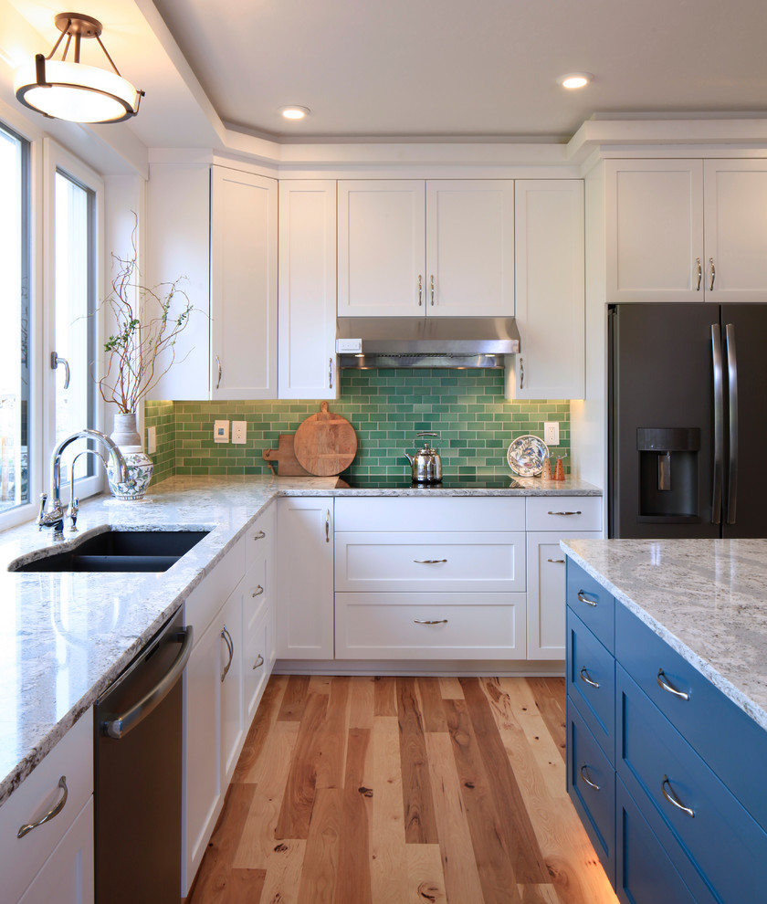 Example of a mid-sized transitional l-shaped medium tone wood floor and beige floor eat-in kitchen design with an undermount sink, shaker cabinets, white cabinets, quartz countertops, green backsplash, subway tile backsplash, stainless steel appliances, an island and multicolored countertops