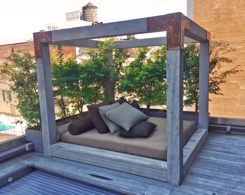 Mid-sized industrial rooftop deck in New York with no cover.