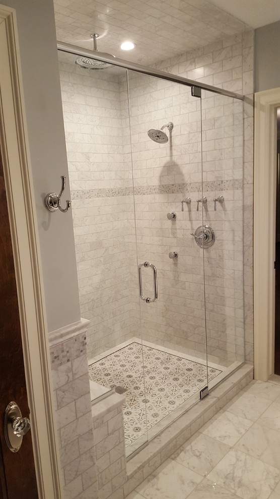 Inspiration for a large traditional master bathroom in Detroit with furniture-like cabinets, dark wood cabinets, a claw-foot tub, a double shower, a two-piece toilet, gray tile, marble, grey walls, marble floors, an undermount sink, marble benchtops, grey floor and a hinged shower door.