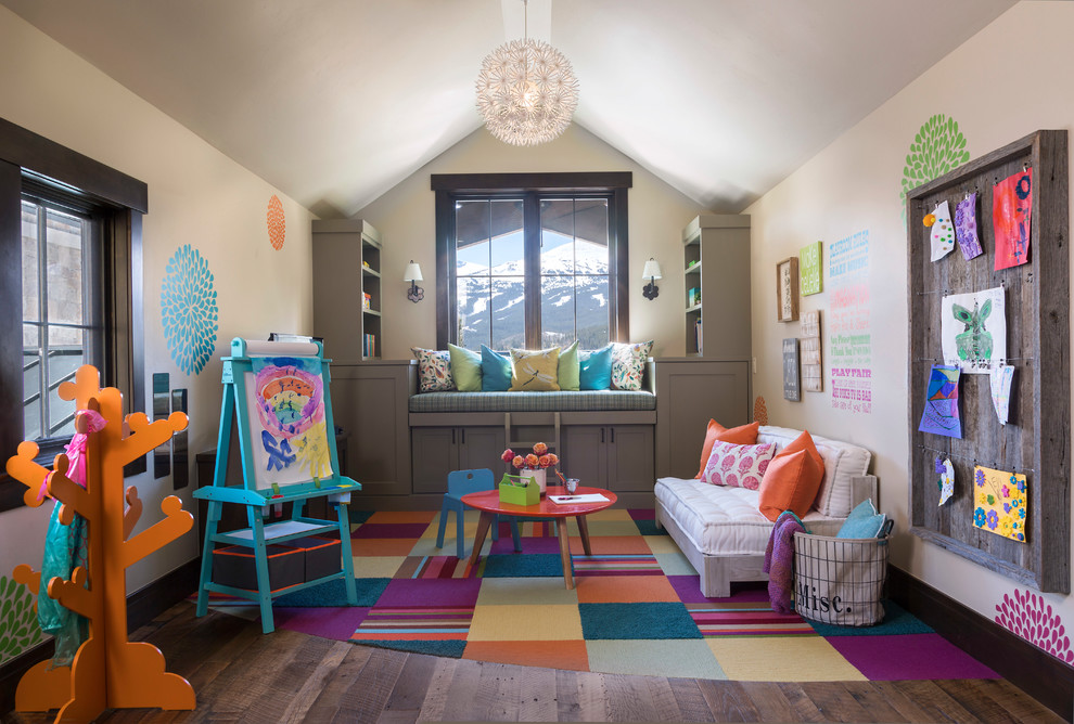Transitional gender-neutral kids' playroom in Denver with beige walls, carpet and multi-coloured floor for kids 4-10 years old.