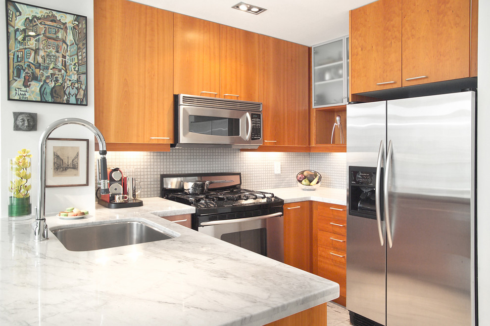 Design ideas for a contemporary kitchen in Toronto with mosaic tile splashback, stainless steel appliances, flat-panel cabinets, medium wood cabinets and an undermount sink.