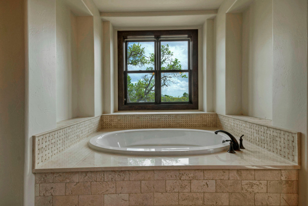 This is an example of a large country master bathroom in Austin with an undermount sink, granite benchtops, a drop-in tub, beige tile, ceramic tile and ceramic floors.
