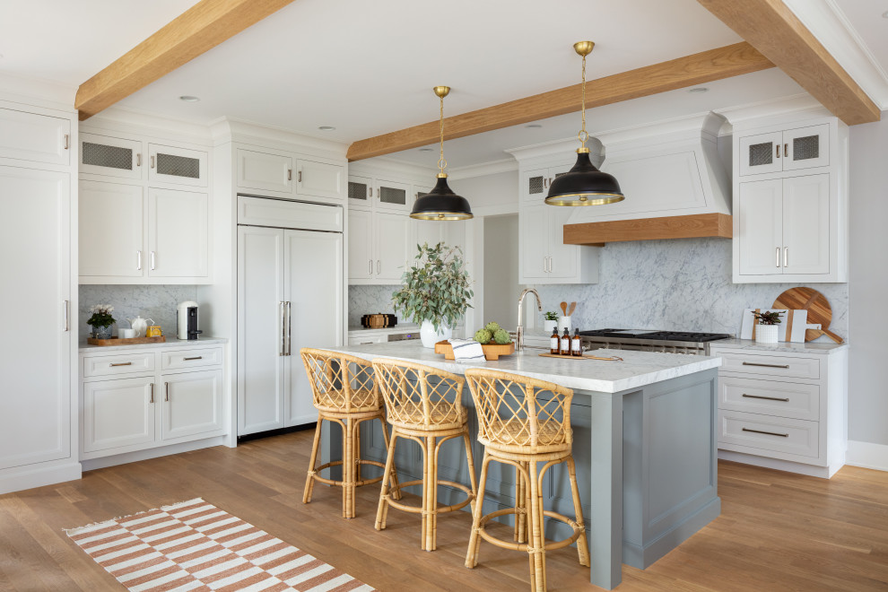 Inspiration for a country l-shaped open plan kitchen in Other with shaker cabinets, an island, white cabinets, grey splashback, stone slab splashback, integrated appliances, medium hardwood flooring, brown floors, white worktops and exposed beams.