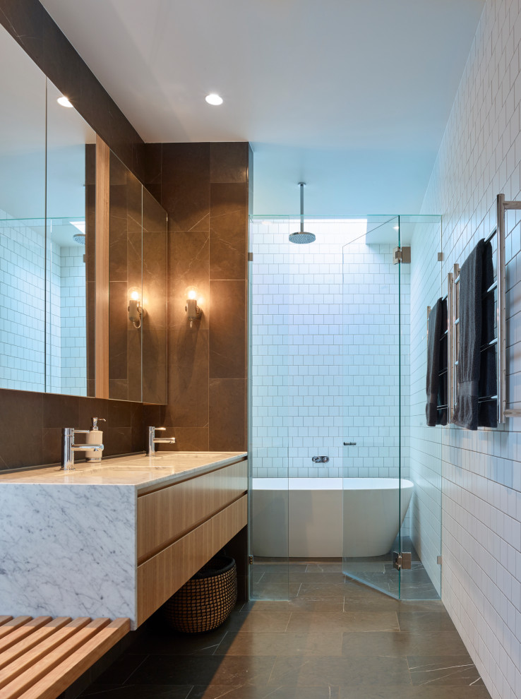 Design ideas for a contemporary wet room bathroom in Brisbane with flat-panel cabinets, medium wood cabinets, a freestanding tub, white tile, an undermount sink, grey floor, grey benchtops and a floating vanity.