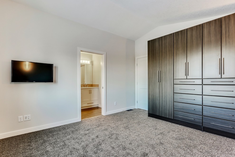 Inspiration for a mid-sized transitional master bedroom in Calgary with white walls and carpet.