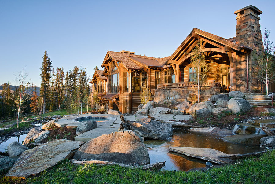 Inspiration for a large rustic partial sun front yard stone pond.