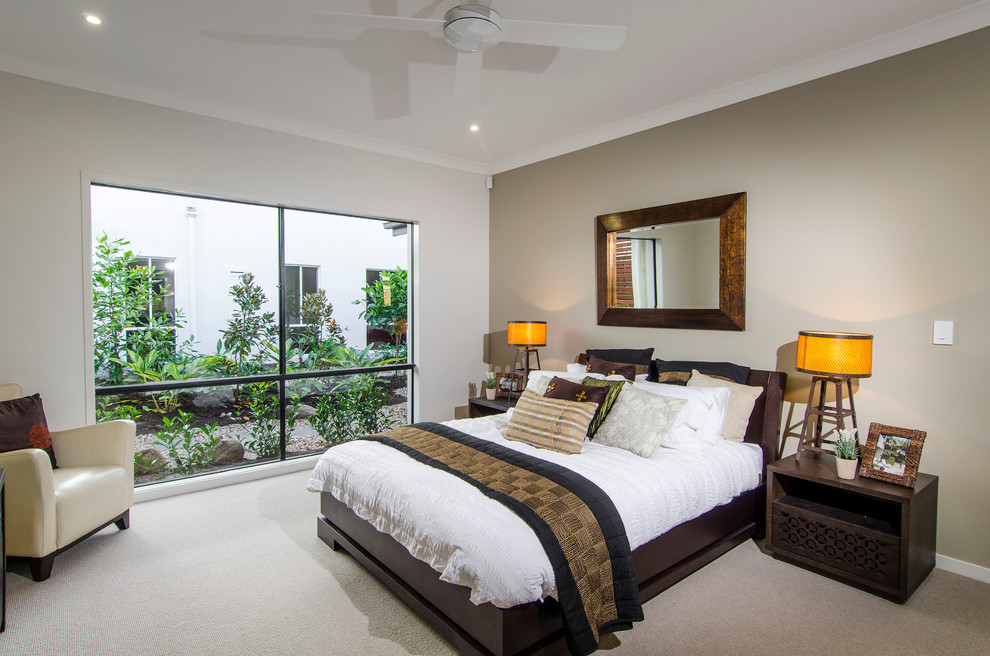 Large master bedroom in Brisbane with beige walls, carpet and no fireplace.