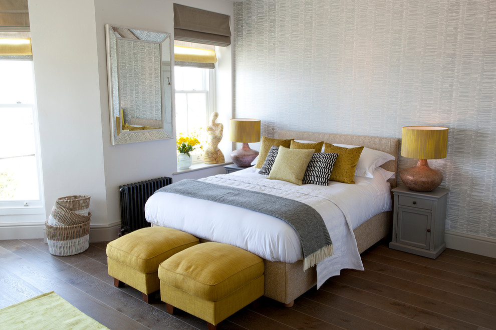 This is an example of a beach style bedroom in Cornwall with grey walls, medium hardwood floors and brown floor.
