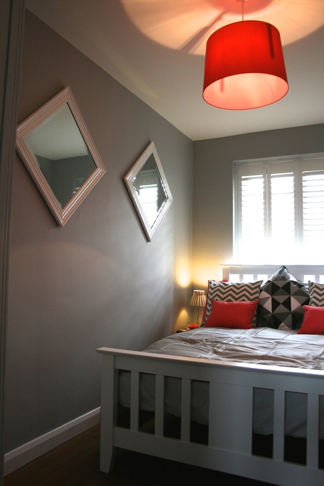 Inspiration for a small contemporary guest bedroom in Manchester with grey walls and medium hardwood floors.