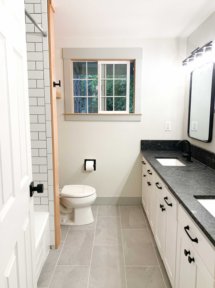 Inspiration for a small classic shower room bathroom in Portland with shaker cabinets, white cabinets, a built-in bath, a shower/bath combination, green tiles, ceramic tiles, green walls, porcelain flooring, a submerged sink, granite worktops, grey floors, a shower curtain, black worktops, double sinks, a built in vanity unit and wood walls.