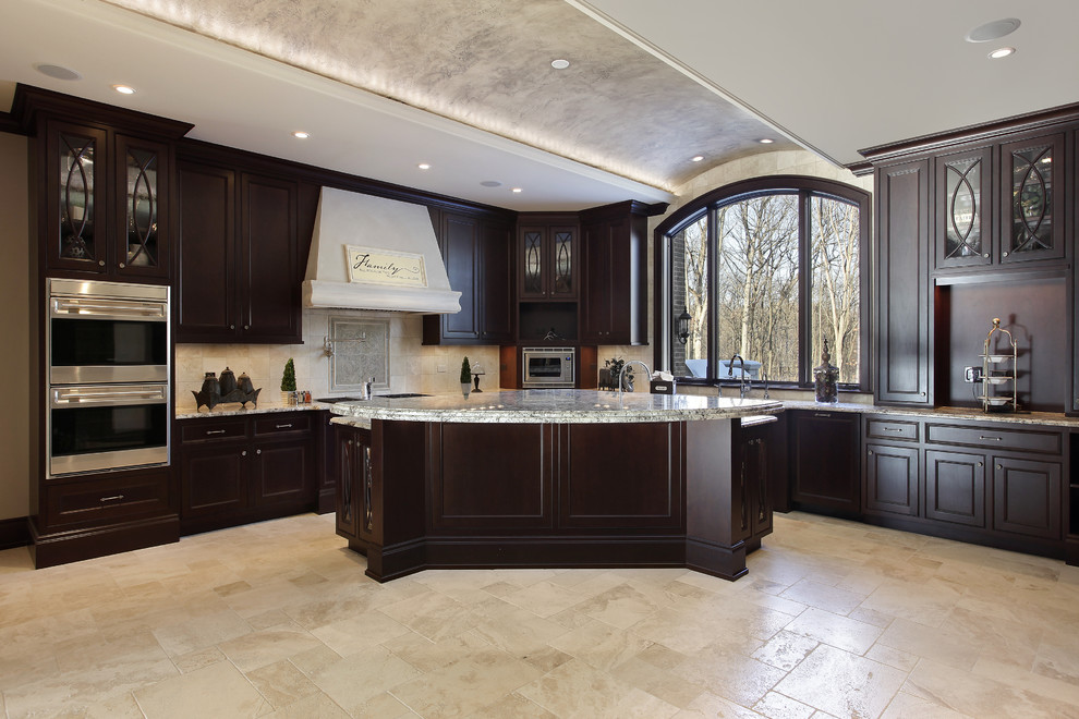 Inspiration for a large traditional l-shaped separate kitchen in Los Angeles with an integrated sink, glass-front cabinets, dark wood cabinets, marble benchtops, stainless steel appliances, ceramic floors, white splashback, ceramic splashback and with island.