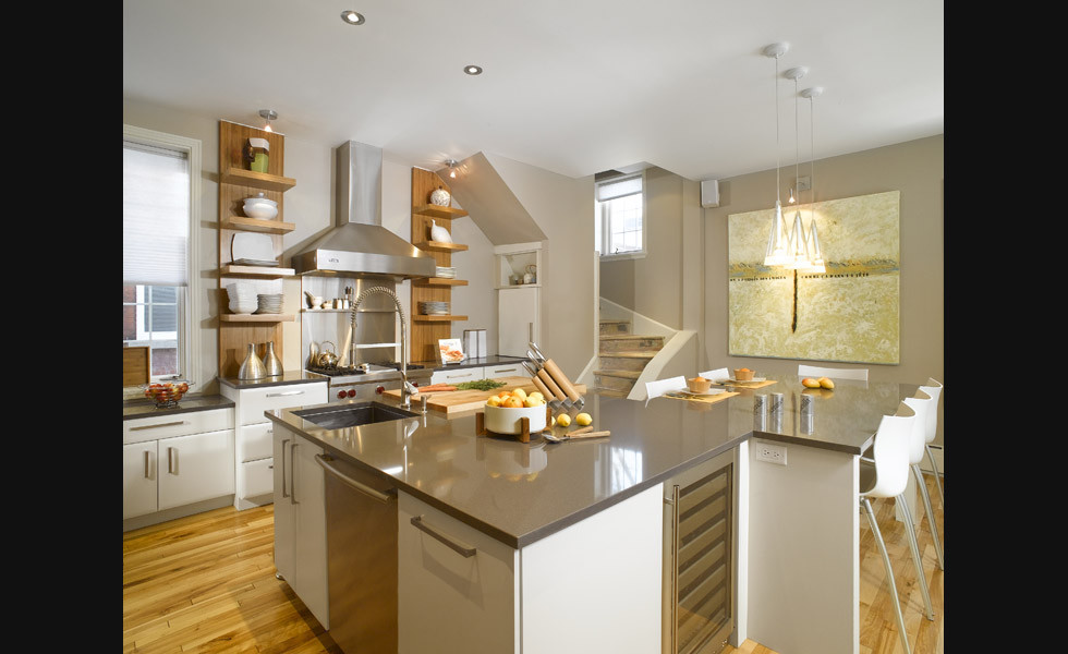 Large modern l-shaped eat-in kitchen in Montreal with an undermount sink, flat-panel cabinets, white cabinets, quartz benchtops, metallic splashback, metal splashback, stainless steel appliances, light hardwood floors and with island.