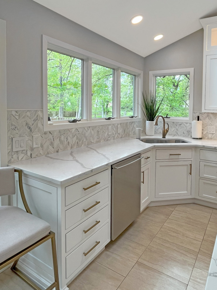 Inspiration for a large transitional eat-in kitchen in Philadelphia with an undermount sink, beaded inset cabinets, white cabinets, quartz benchtops, grey splashback, porcelain splashback, stainless steel appliances, porcelain floors, with island, brown floor, white benchtop and vaulted.
