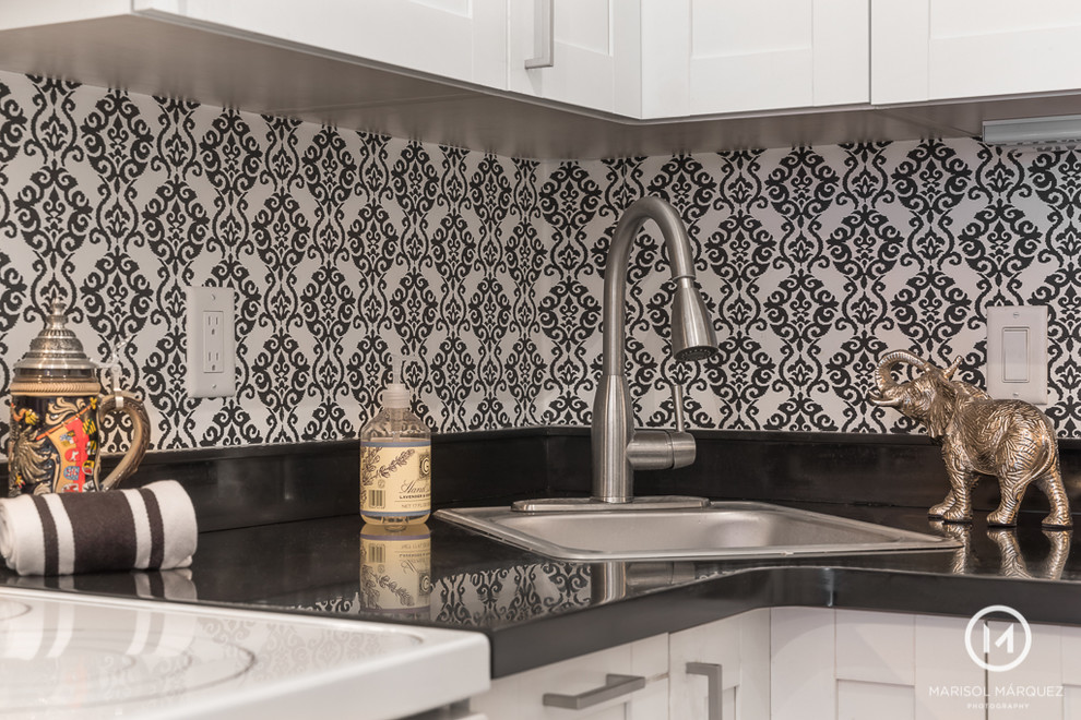Kitchen - eclectic galley medium tone wood floor kitchen idea in Boston with raised-panel cabinets, no island, white cabinets, quartz countertops and black countertops