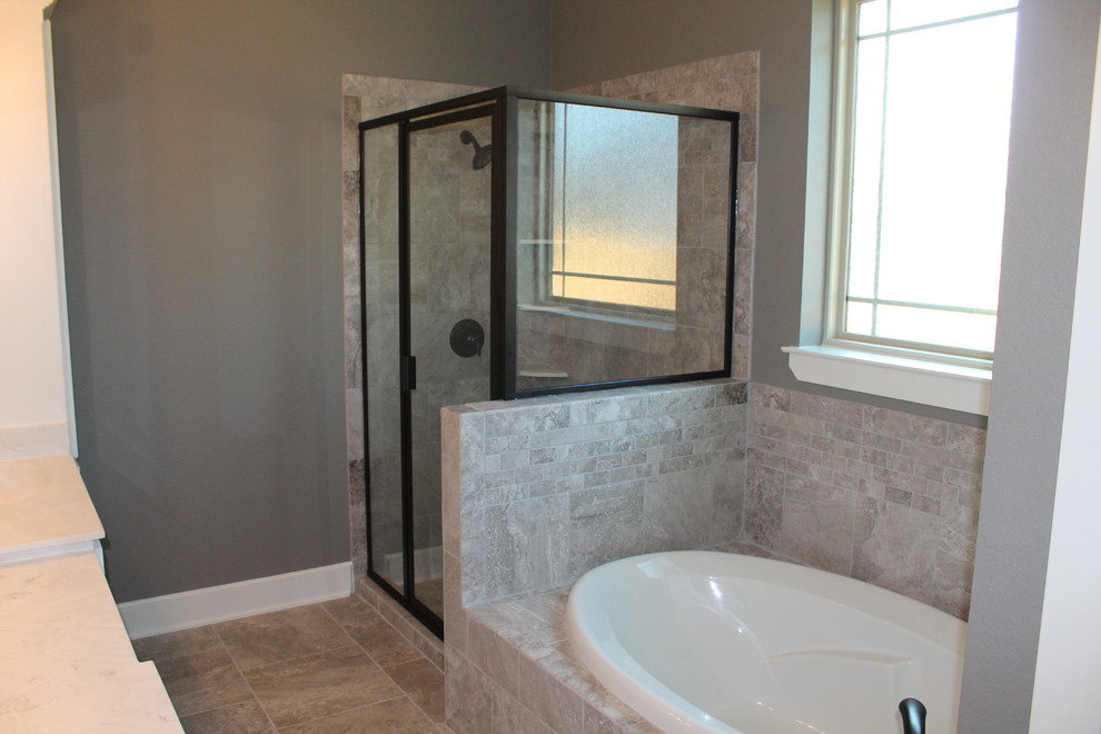 Mid-sized contemporary master bathroom in Dallas with an integrated sink, raised-panel cabinets, white cabinets, solid surface benchtops, a drop-in tub, a corner shower, a two-piece toilet, gray tile, ceramic tile, grey walls and ceramic floors.