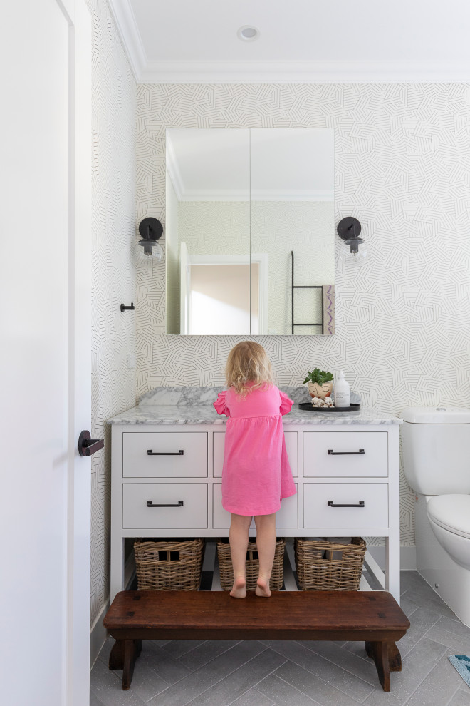 Design ideas for a mid-sized kids bathroom in Brisbane with a freestanding tub, marble benchtops, a hinged shower door, grey benchtops, a single vanity, a freestanding vanity and wallpaper.
