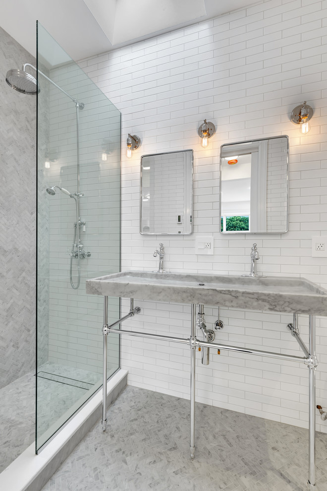 Photo of a transitional bathroom in New York with an alcove shower, white tile, subway tile, mosaic tile floors, a console sink and grey floor.