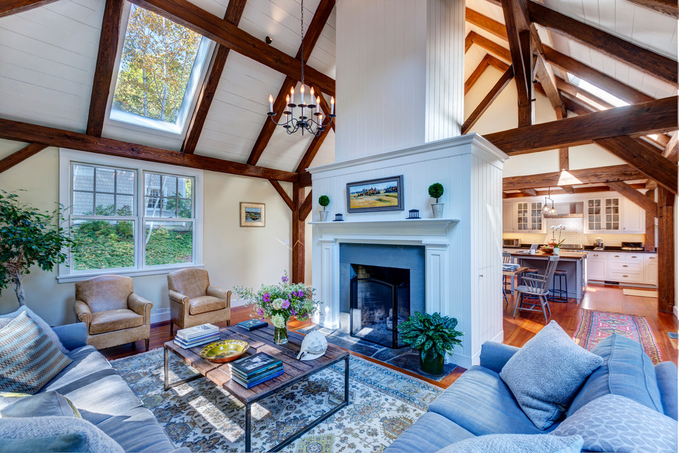 This is an example of a mid-sized traditional open concept living room in Burlington with medium hardwood floors, a standard fireplace and a stone fireplace surround.