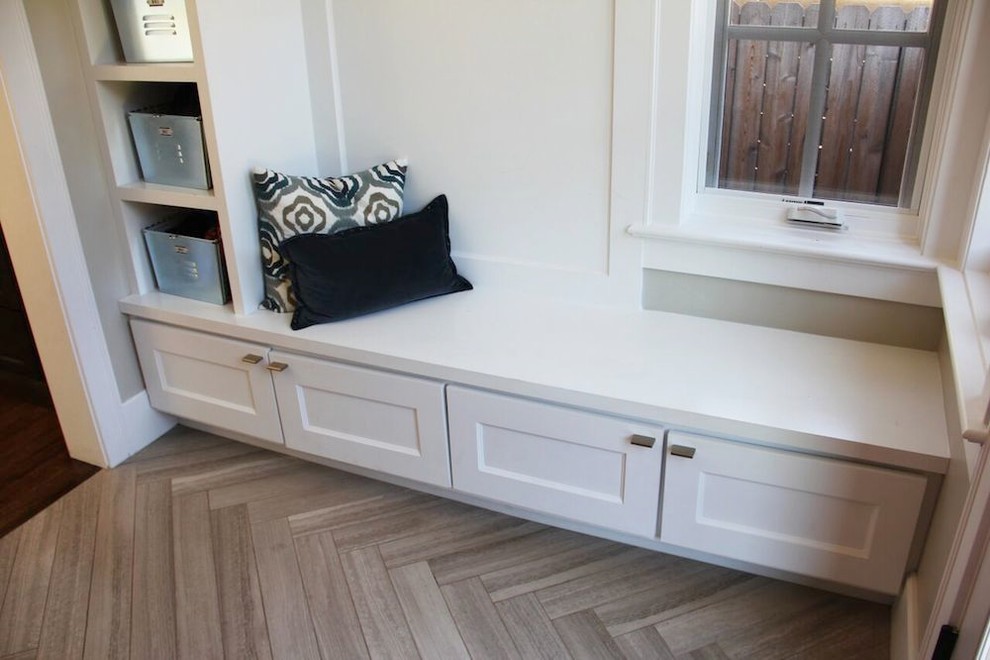 Design ideas for a small contemporary mudroom in Denver with grey walls, limestone floors and brown floor.