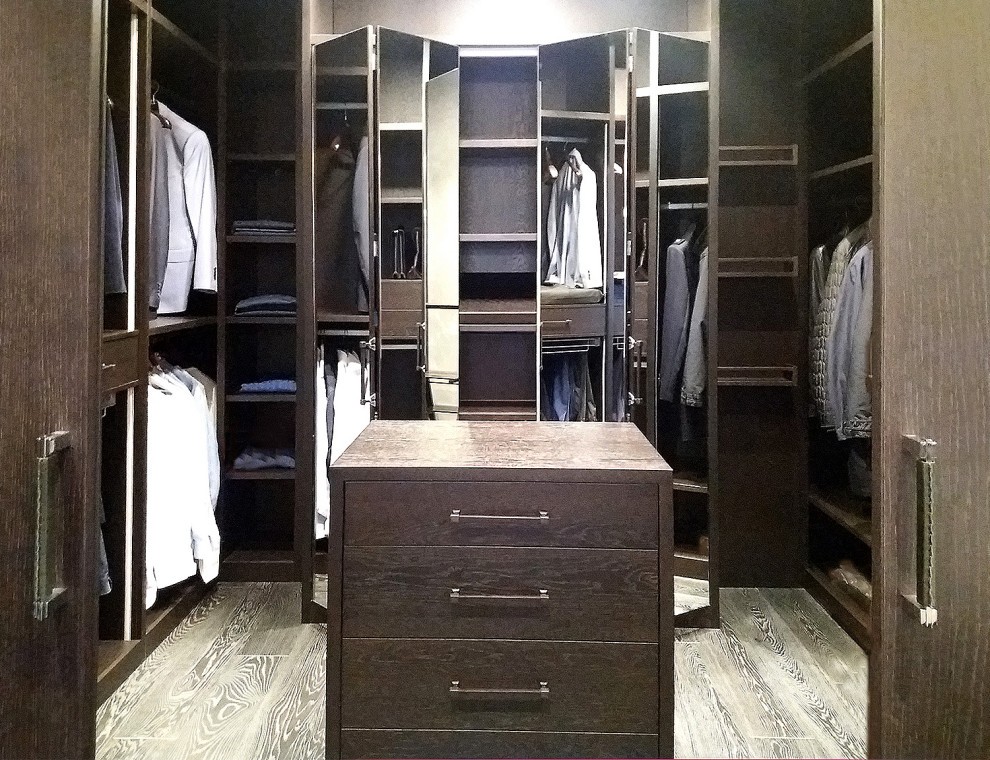 Photo of a large contemporary men's walk-in wardrobe in Moscow with open cabinets, dark wood cabinets, painted wood floors and black floor.