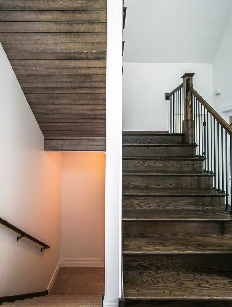 Wooden u-shaped wood railing staircase photo in Chicago with wooden risers