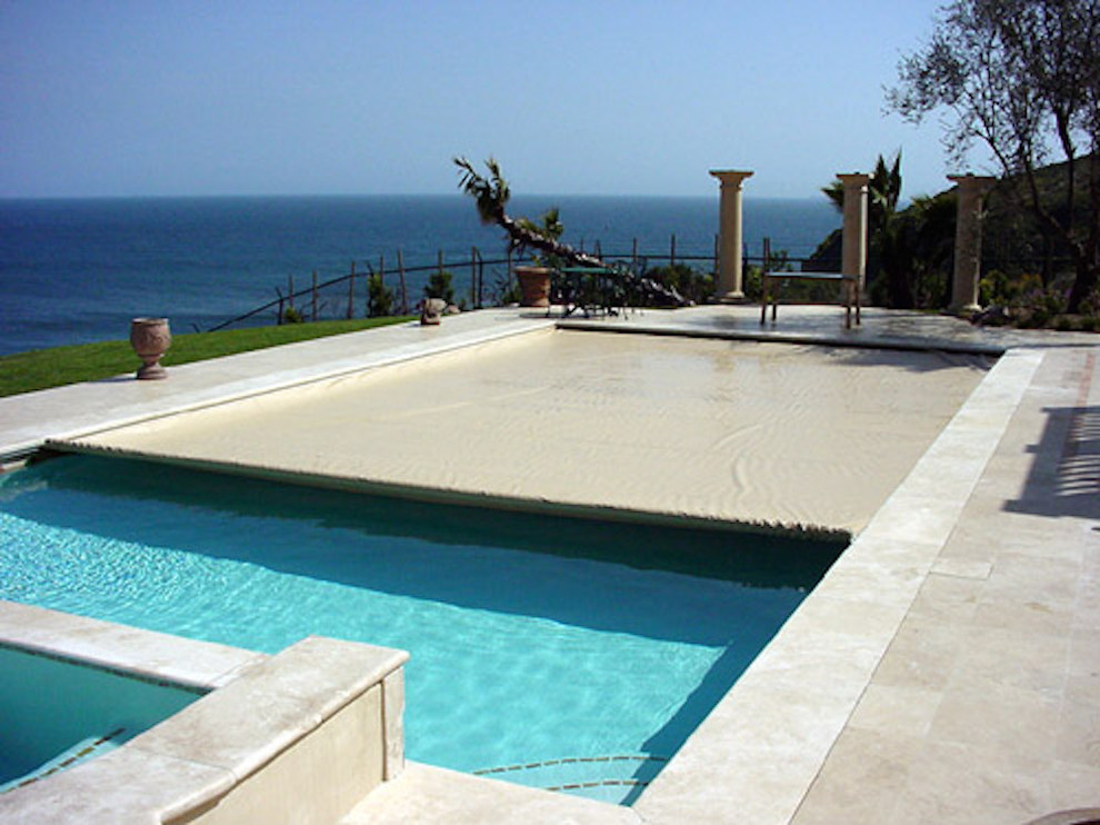 Large concrete and rectangular hot tub photo in Miami
