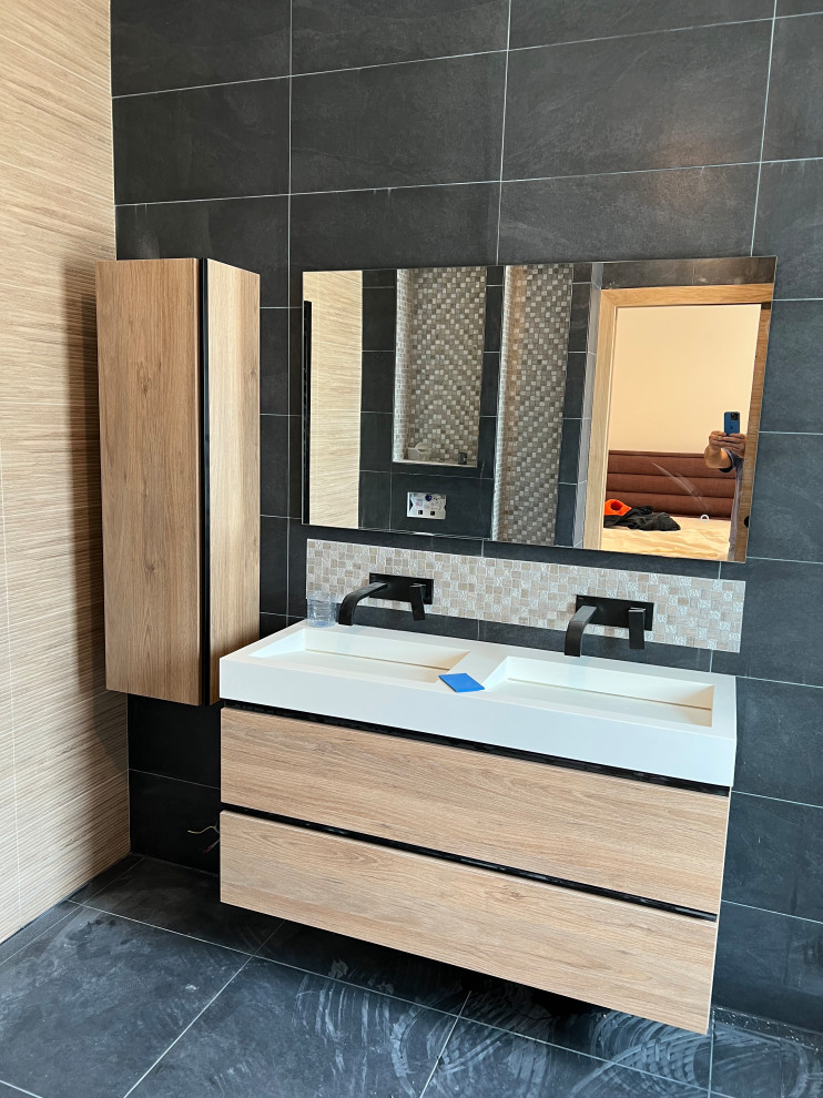 This is an example of a mid-sized contemporary master bathroom in Paris with beaded inset cabinets, brown cabinets, a curbless shower, gray tile, a wall-mount sink, wood benchtops, grey floor, an open shower, white benchtops, a double vanity, a floating vanity, coffered and wood walls.